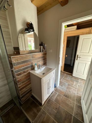 a bathroom with a sink and a mirror at apartman slovensky raj in Spišský Štiavnik