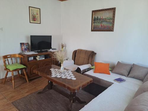 ein Wohnzimmer mit einem Sofa und einem Tisch in der Unterkunft Vikendica Borje in Žabljak