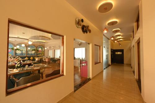 a corridor of a building with a dining room at THE GANGA RESORT in Bikaner
