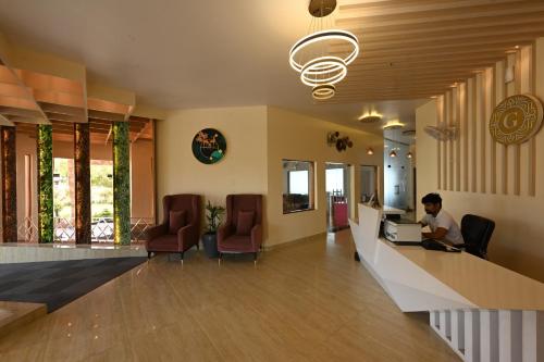 a man sitting at a desk in a hospital lobby at THE GANGA RESORT in Bikaner