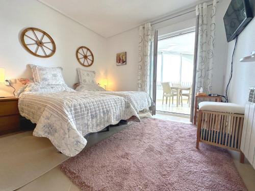 a bedroom with a bed and a large window at Golf View Apartment in Sucina