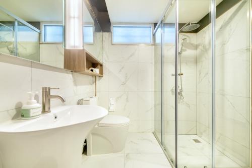a bathroom with a sink and a shower at Qiu Hotel Sukhumvit SHA Plus in Bangkok