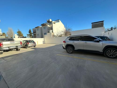 a white car parked in a parking lot at Simonetta in Puerto Madryn