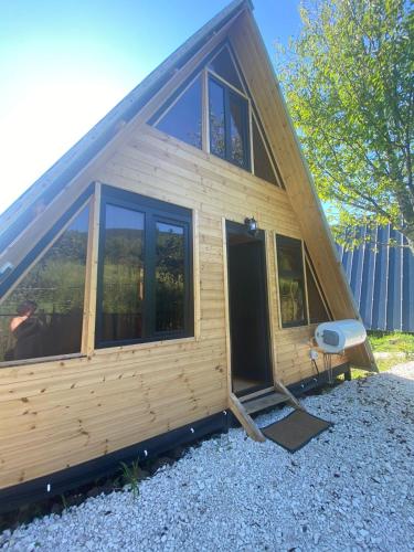 a small wooden cabin with a large window at Inn Martvili in Martvili