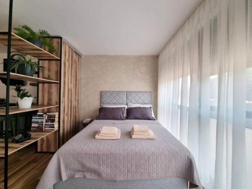 a bedroom with a bed with two towels on it at Studio More Amore Dubrovnik in Dubrovnik
