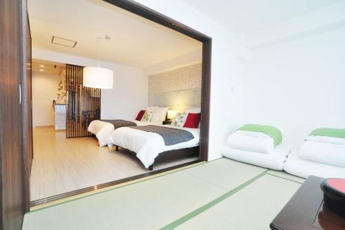 a large mirror in a room with a bedroom at guest house Sakura in Osaka