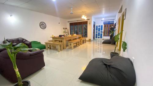 a living room with couches and a table in the background at Happy Hammocks, Hiriketiya Beach - Sri Lanka in Hiriketiya
