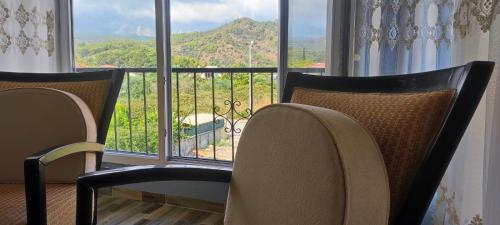two chairs in front of a window with a view at nado in Kemer