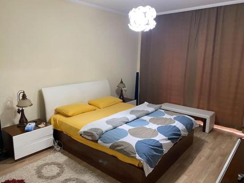 a bedroom with a bed and a chandelier at Prestij beykent rezidance in Buyukcekmece