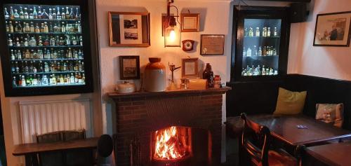 a bar with a fireplace and a fire place at Cornish Arms Inn Port Isaac 2 miles in Port Isaac