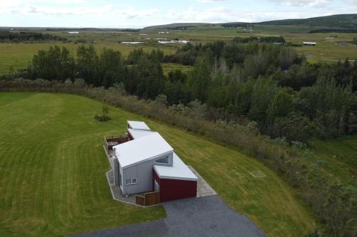 an overhead view of a building on a grass field at Stunning house - amazing scenery in Hvolsvöllur