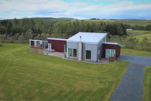 an aerial view of a house in a field at Stunning house - amazing scenery in Hvolsvöllur