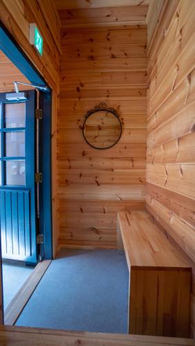 a sauna with a bench in a wooden wall at Wadano Gateway Suites & Apartments in Hakuba