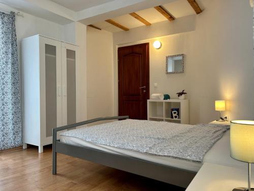a bedroom with a bed in a room with a door at Villa Chingo in Ohrid