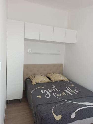 a bed with two pillows on it in a bedroom at Maison, rue calme dans village in Saint-Mitre-les-Remparts