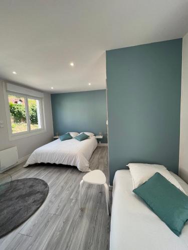 a bedroom with two beds and a chair in it at Maison in Enquin-sur-Baillons
