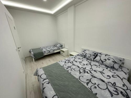 1 dormitorio con 1 cama grande y 2 camas sidx sidx sidx sidx en Apartmani City Foča, en Foča