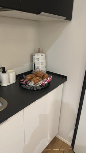 a plate of donuts on a counter in a kitchen at Centro Storico Caruggi 2min Acquario Pellicceria Superior Loft Palazzo Rolli in Genova