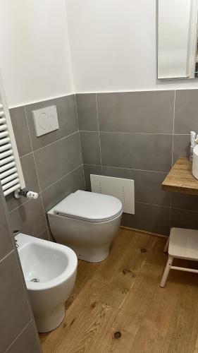 a bathroom with a toilet and a sink at Centro Storico Caruggi 2min Acquario Pellicceria Superior Loft Palazzo Rolli in Genova