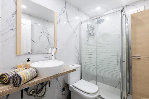 a bathroom with a toilet and a sink and a shower at Apartment in Playa de las Americas in Playa de las Americas