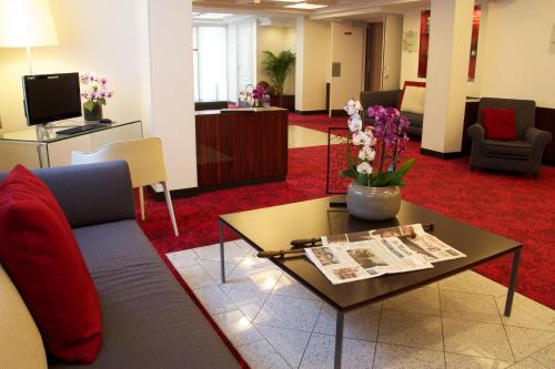 a living room with a couch and a coffee table at Hotel Le Richemont in Paris