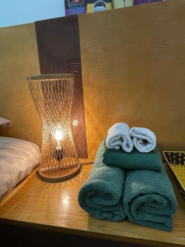 a room with a table with towels and a lamp at Hidden gem homestay 2 in Hanoi