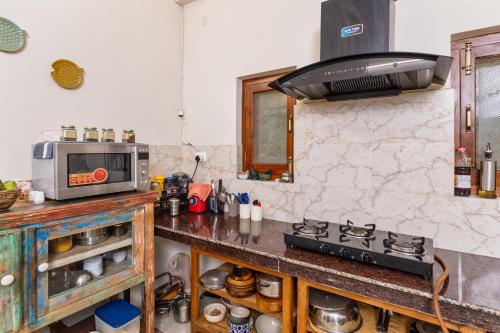 a kitchen with a stove and a microwave on a counter at Villa by Mountain Homes- Lansdowne in Lansdowne