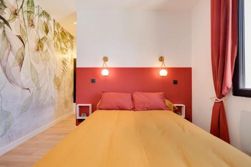 a bedroom with a bed with a red head board at Maison de charme Bordeaux Bègles in Bègles