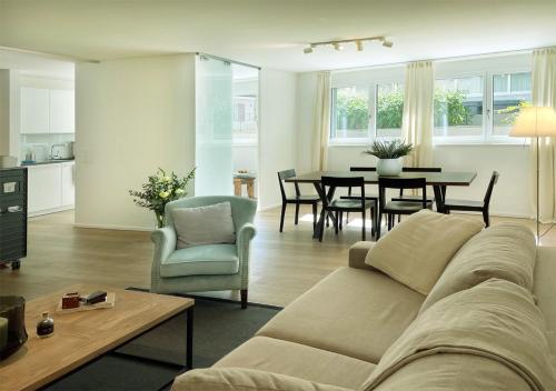 a living room with a couch and a table at Stay at Night - Moonlight in Zürich