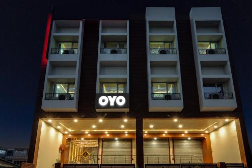 an apartment building with an ovy sign on it at Townhouse Hotel Trijal Inn in Lucknow