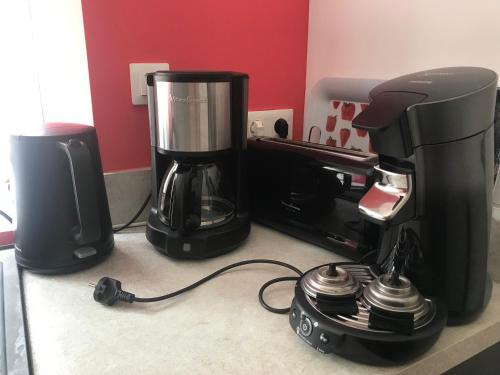 a coffee maker and a blender on a counter at Gîtes Le Mas du Vieux Chêne in Salavas