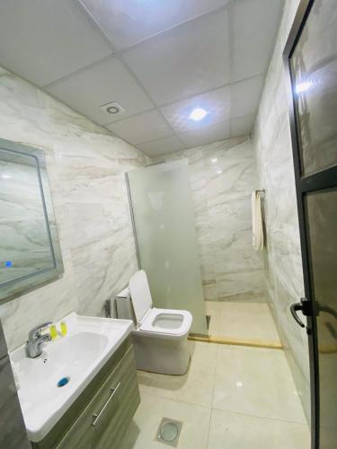 a bathroom with a toilet and a sink at Syndebad desert camp in Wadi Rum