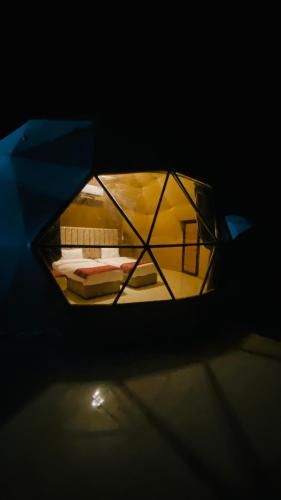 a view of a room with a bed in the dark at Syndebad desert camp in Wadi Rum
