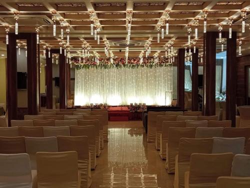 a large hall with rows of chairs and a stage at PRIME LAND in Varanasi