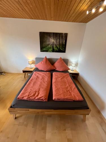 a bed in a room with two tables at Haus am Sonnenberg, Todtnauberg, Ferienwohnung 204, direkt am Skilift-Skipiste, Nähe Feldberg in Todtnau