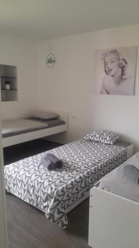 a bed in a room with a picture on the wall at Apartma Ana in Koper