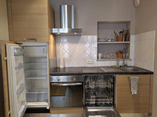 Il comprend une cuisine équipée d'une cuisinière et d'un réfrigérateur. dans l'établissement Bel appartement dans centre historique avignon, à Avignon