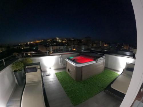 a view of a balcony with a bed and grass at 18 Dante Luxury Suites in Cagliari