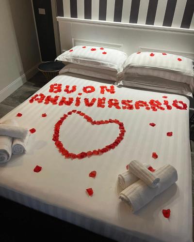 a bed with a heart made out of hearts on it at 18 Dante Luxury Suites in Cagliari