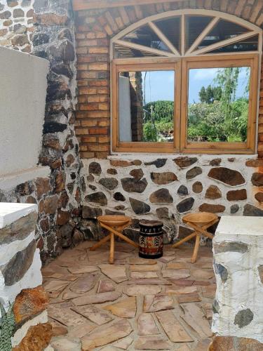 a room with a window and a stone wall at GKAT Resort in Mbarara