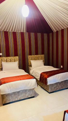 a room with two beds in a tent at Syndebad desert camp in Wadi Rum