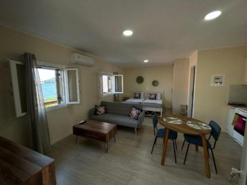 a living room with a couch and a table at Anmare Studios in Nydri