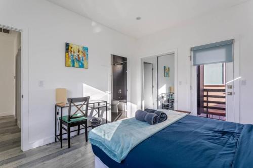 a bedroom with a blue bed and a chair at Cheerful 4BR home with parking in East Hollywood in Los Angeles