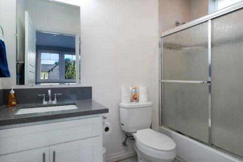 a bathroom with a toilet and a sink and a shower at Comfy 4BR home near Korea Town in Los Angeles