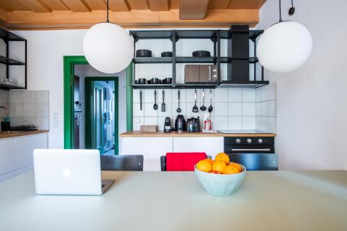 a kitchen with a table with a bowl of oranges at Flattering - Berlin in Berlin