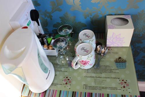 a table with dishes and other items on it at Invergarry Room Only Guest House For Adults in Windermere