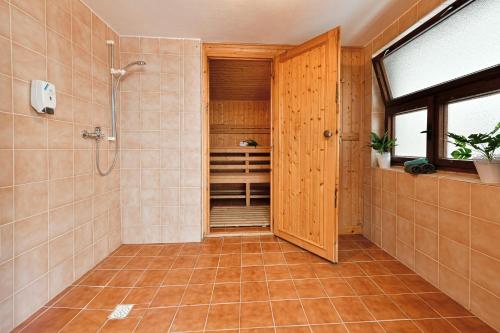 a bathroom with a shower and a walk in closet at Apartmány orlík in Klučenice