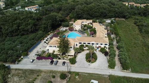 an aerial view of a house with a swimming pool at Karavostasi Beach Hotel in Perdika