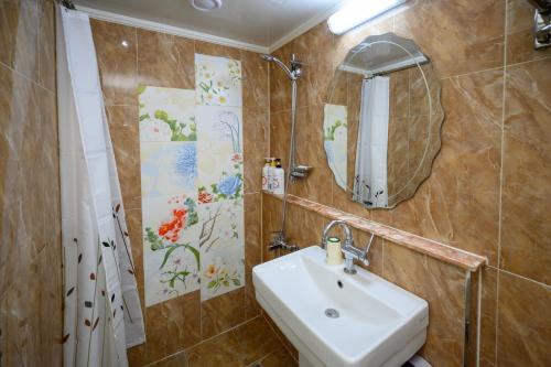 a bathroom with a sink and a mirror at Daeyoung Hotel Myeongdong in Seoul