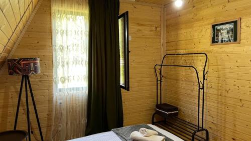 a bedroom with a bed and a window and a television at Cottage Mida in Mestia